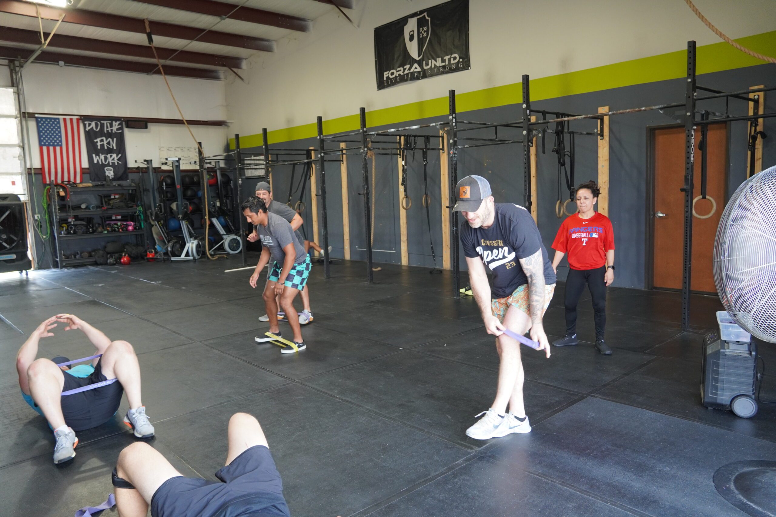group of gym members, warming up for weight lifting
